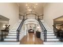 Two-story foyer with a grand staircase and hardwood floors at 3012 Wheatfield Dr, Waxhaw, NC 28173