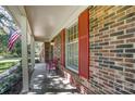 Side view of front porch with red bench and red shutters at 816 Nightingale Rd, Rock Hill, SC 29732