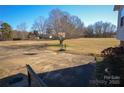 View of a spacious driveway with a basketball hoop, surrounded by a well-maintained yard and mature trees at 2725 Carla Dr, Shelby, NC 28150