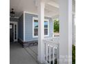 Inviting front porch with white columns and stone accents, offering a welcoming entrance to the home at 4684 Hopsack Dr # Cal0105, Indian Trail, NC 28079