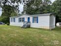 Charming single-story home featuring blue shutters and a spacious front lawn at 6261 Burnhurst Ln, Denver, NC 28037