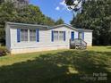 Inviting single-story house, showcasing blue shutters, set against a clear sky at 6261 Burnhurst Ln, Denver, NC 28037