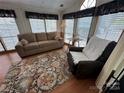 Comfortable living room with large windows, blinds, and stylish decor at 193 Marina Dr, New London, NC 28127