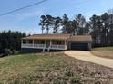 Inviting single-story house showcasing a covered front porch and a two-car garage at 2290 9Th Avenue Ne Dr, Hickory, NC 28601