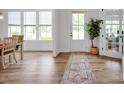 Bright foyer with hardwood floors, a stylish rug, and a view of the front door and living area at 7245 Static Way, Sherrills Ford, NC 28673