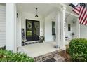 Inviting front porch features a black door and white columns at 5811 Kristi Ln, Midland, NC 28107