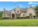 Elegant brick home with a manicured lawn at 8516 Mcilwaine Rd, Huntersville, NC 28078