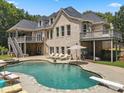 Luxury home with a beautiful pool and expansive patio at 8516 Mcilwaine Rd, Huntersville, NC 28078