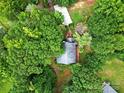 An aerial view shows a house surrounded by lush greenery, with a driveway and walkway leading to the entrance at 9143 Sadlers Ridge Rd, Fort Mill, SC 29707