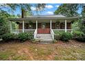 Charming brick home featuring a covered front porch with white railing at 9143 Sadlers Ridge Rd, Fort Mill, SC 29707