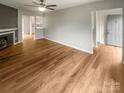 Spacious living room featuring fireplace, fan, and seamless flow into the kitchen at 6003 Heath Valley Rd, Charlotte, NC 28210