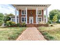 House exterior with columns, brick pathway, and porch swing at 903 W Franklin St, Monroe, NC 28112