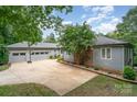 Home with a spacious driveway, large garage and beautiful landscaping at 3020 Poplar Hill Rd, Charlotte, NC 28270