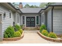 Charming home featuring a landscaped entryway, stone walkway, and grand double doors at 3020 Poplar Hill Rd, Charlotte, NC 28270