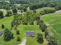 Sprawling acreage featuring a charming home surrounded by lush greenery and mature trees at 131 Sam Smith Rd, Kings Mountain, NC 28086