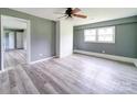 Bright living room with wood-look floors, a brick accent wall, and ample natural light at 131 Sam Smith Rd, Kings Mountain, NC 28086