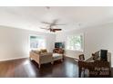 Bright living room with hardwood floors, comfortable seating, and a piano at 5601 Indian Brook Dr, Matthews, NC 28104