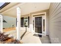 Covered front porch with black front door and white columns at 8611 Frank Grier Rd # 1, Charlotte, NC 28215
