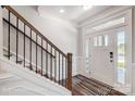Elegant staircase with white risers and dark wood handrail at 8611 Frank Grier Rd # 1, Charlotte, NC 28215