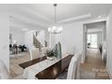Bright dining area with modern lighting, hardwood floors, and views of the staircase and entryway at 5225 Glenwalk Dr # 0061, Charlotte, NC 28269