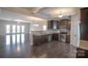 Modern kitchen featuring dark wood cabinets, stainless steel appliances, and granite countertops at 147 Fesperman Cir, Troutman, NC 28166