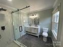 Modern bathroom featuring a walk-in shower and double vanity at 647 Reeves Ct, Charlotte, NC 28208