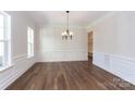 Formal dining room with hardwood floors, wainscoting, and chandelier at 1025 Patterson Farm Rd, Mooresville, NC 28115