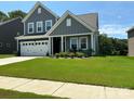 Well-maintained home with lush green lawn and a double-door garage at 8165 Annsborough Nw Dr, Concord, NC 28027
