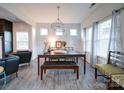 Bright dining room featuring a wood table and stylish light fixture at 209 Meyers Ridge Rd, Cramerton, NC 28032