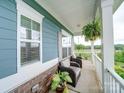 Inviting front porch with seating area, overlooking scenic landscape at 209 Meyers Ridge Rd, Cramerton, NC 28032