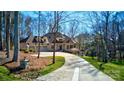 Stunning stone home with a three-car garage, long driveway and lush, green lawn at 301 Agnew Rd, Mooresville, NC 28117