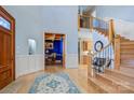 Elegant foyer featuring hardwood floors, staircase with iron railing and a view into the office at 301 Agnew Rd, Mooresville, NC 28117