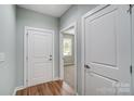 Bright hallway with two closed doors and wood flooring at 1511 28Th Street Se Pl, Hickory, NC 28602