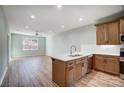 Open kitchen with island, stainless steel appliances, and light wood cabinets at 1511 28Th Street Se Pl, Hickory, NC 28602