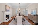 Elegant dining room featuring hardwood floors, a fireplace, and large windows at 170 Old Post Rd, Mooresville, NC 28117