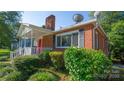 Brick ranch house with a red front door and white porch at 609 Rowan Mills Rd, Salisbury, NC 28147