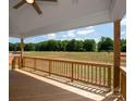 Relaxing back deck offering serene views of the lush green landscape and a blue sky at 4808 Glen Stripe Dr # Cal0036, Indian Trail, NC 28079