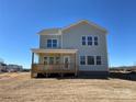 Rear exterior showcasing a two-story home with a wooden deck and expansive backyard at 4808 Glen Stripe Dr # Cal0036, Indian Trail, NC 28079