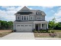Inviting two-story home featuring a spacious two-car garage, stone accents, and a welcoming front porch at 4808 Glen Stripe Dr # Cal0036, Indian Trail, NC 28079