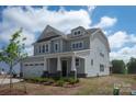 Well-lit two-story home with attached garage, manicured landscaping, and welcoming front porch at 4808 Glen Stripe Dr # Cal0036, Indian Trail, NC 28079
