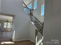 Bright foyer featuring staircase with metal spindles and hardwood floors and natural light at 4808 Glen Stripe Dr # Cal0036, Indian Trail, NC 28079