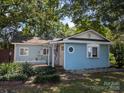 View of a charming house with light blue siding, well-kept landscaping, and a welcoming entrance at 209 21St St, Newton, NC 28658