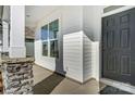 Front entrance with stone pillars and a black front door at 5304 Verona Rd # 76, Charlotte, NC 28213