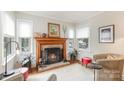 Comfortable living room with a brick fireplace, bright windows and stylish furnishings at 1007 Ashford St, Charlotte, NC 28214