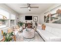 Bright living room featuring stylish decor, a modern ceiling fan, and neutral color palette at 1007 Ashford St, Charlotte, NC 28214