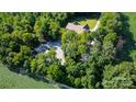 Expansive property featuring a home and outbuilding surrounded by mature trees at 423 Old Dutch Rd, Indian Trail, NC 28079