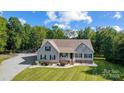 Beautiful home exterior, featuring lush landscaping and a well-maintained lawn at 423 Old Dutch Rd, Indian Trail, NC 28079