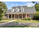 Spacious brick home with a large front porch and mature trees at 721 Orphanage Rd, Concord, NC 28027