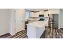 Modern kitchen with white cabinets, quartz countertops, and stainless steel appliances at 1610 Cannonball Ln, Bessemer City, NC 28016