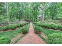 Beautifully landscaped brick pathway leading to a home surrounded by lush greenery at 715 Saint Cloud Dr, Statesville, NC 28625